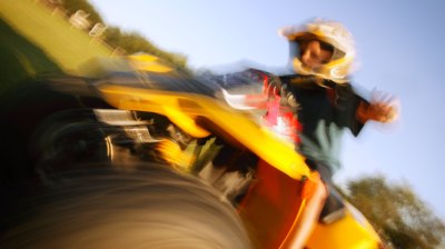 Boy riding an All-Terrain Vehicle