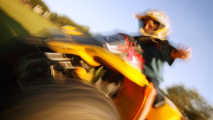 Boy riding an All-Terrain Vehicle