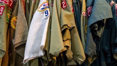 Boy Scout uniforms hanging in closet